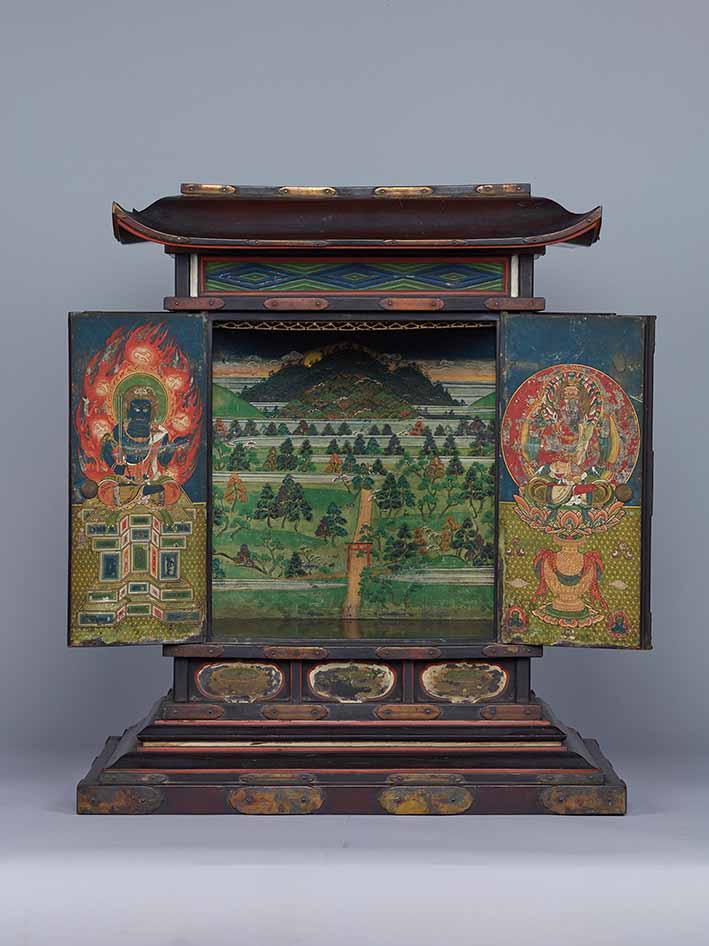 Kasuga Mandala Reliquary Shrine, 1479, lacquered wood with colour, Muromachi period (1392-1573), 55.6 x 39.7 x 48 cm, Tokyo National Museum (in rotation two, 23 May to 30 June). This miniature shrine, said to be an architectural representation of Takemikazuchi, the kami of the first shrine at Kasuga Taisha, was meant to contain relics of the historical Buddha Shakyamuni, Takemikazuchi’s Buddhist counterpart. On the front doors are Aizen Myoo, wisdom king of passion (right) and Fudo Myoo, wisdom king of immovability (left). The side doors show the guardian kings of the four directions. The back wall inside the shrine vividly portrays a view of the landscape of Kasuga Taisha. Based on other examples, we can assume that a gem-shaped reliquary would once have been installed in the middle. Photo: TNM Image Archives